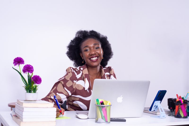 Smiling business owner running her insurance book on Geeno